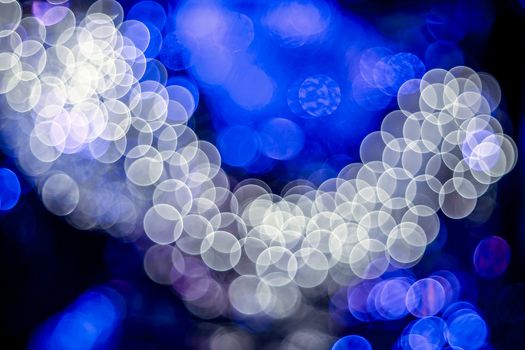 Blue background of abstract booble bokeh white lights. Natural defocused photo. Christmas light blurred, abstract background. Garland. Copy space.