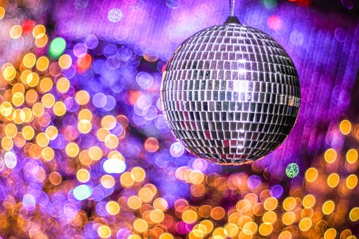 Disco ball with with bokeh defocused lights. Night party background photo. Disco party. Blurred, abstract background. Copy space.