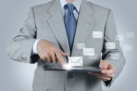 businessman hand use tablet computer with email icon