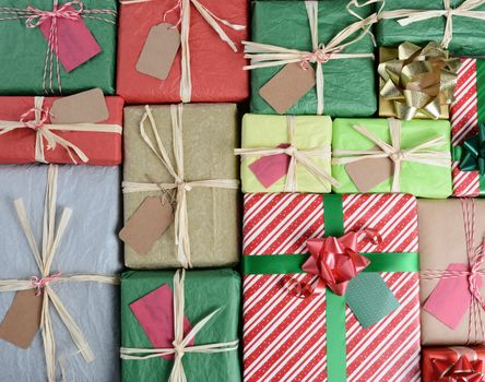 High angle shot of a large group of Christmas Presents. Wrapped in various papers and styles the the image fills the frame.