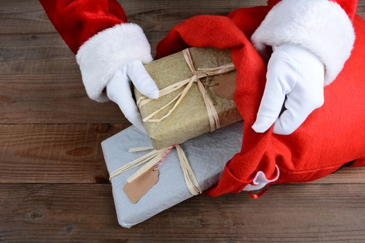 Closeup of Santa Claus putting packages in his bag on Christmas Eve. 