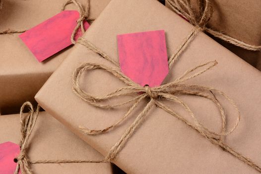 Closeup of a group of Christmas presents wrapped with brown eco friendly craft paper. Horizontal format.