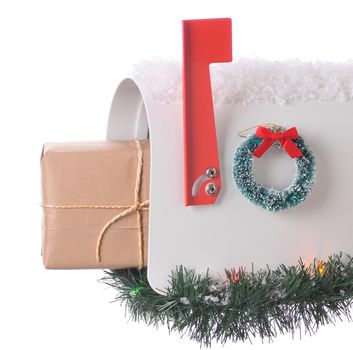 Package sticking out of and open mailbox decorated for christmas isolated on white. Square Composition