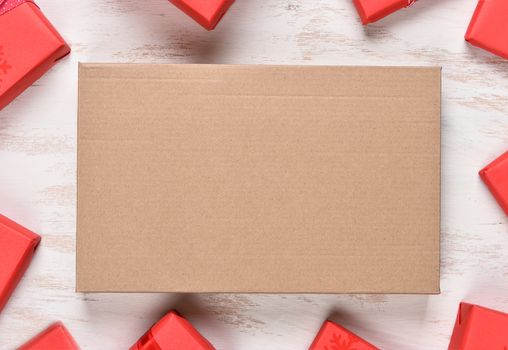 Red Christmas Present frame surrounding a plain brown box with copy space