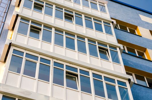 modern house with yellow and blue walls and empty windows without people quarantine isolation