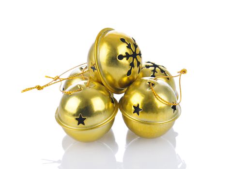 A group of jingle bells on a white background with reflection.