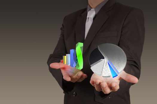 businessman hand drawing a pie chart and 3d graph