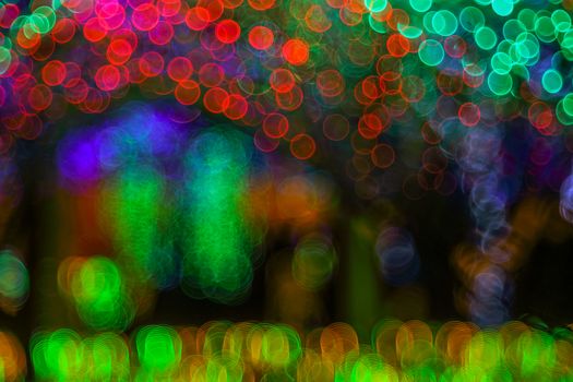 Abstract twinkled bright background with defocused lights. Majestic tree of lights. Fantastic forest. Background with bubble bokeh lights. 