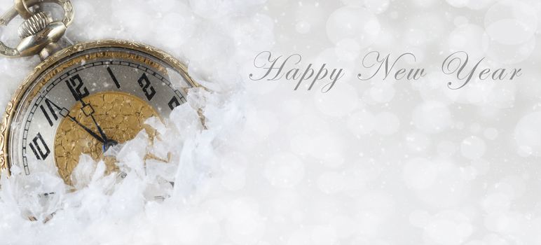 Happy New Year banner size image with a pocket watch partially covered with snow and room for your copy.