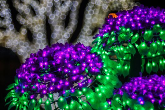 Festive abstract background with bubble bokeh defocused lights. Majestic tree of lights. Fantastic forest. Copy space.