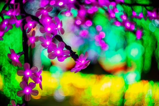 Sakura branch. Abstract background with bubble bokeh defocused lights. Majestic tree of lights. Fantastic forest.  