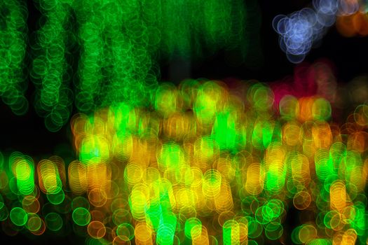 Festive abstract background with bubble bokeh defocused lights. Majestic tree of lights. Fantastic forest. Copy space.