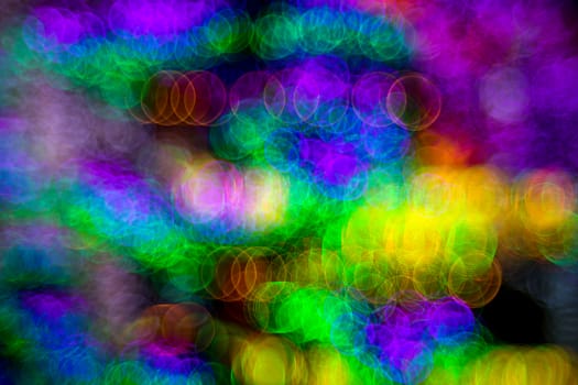 Background of abstract bubble bokeh lights. Natural defocused photo. Christmas light blurred, abstract background. Neon color. Copy space.