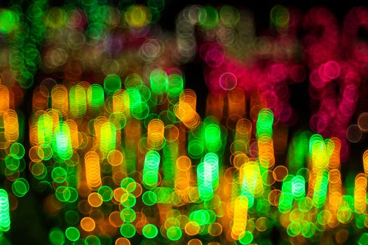 Festive abstract background with bubble bokeh defocused lights. Majestic tree of lights. Fantastic forest. Copy space.