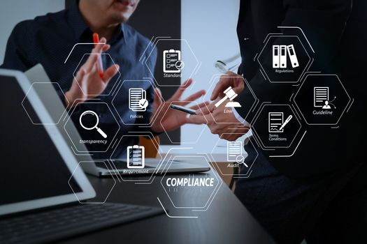 Compliance Virtual Diagram for regulations, law, standards, requirements and audit.co working team meeting concept,businessman using smart phone and digital tablet and laptop computer in modern office