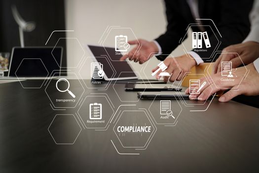 Compliance Virtual Diagram for regulations, law, standards, requirements and audit.co working team meeting concept,businessman using smart phone and digital tablet and laptop computer in modern office