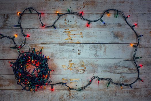 Christmas background with colorful lights and free text space. Christmas lights frame. Garland. Flat lay, top view, copy space. 