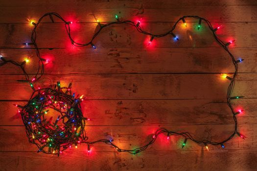 Christmas background with colorful lights and free text space. Christmas lights frame. Garland. Flat lay, top view, copy space. 