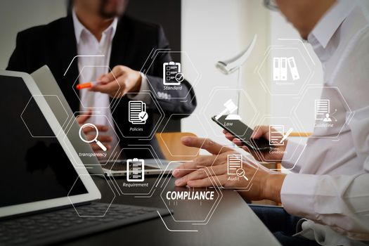 Compliance Virtual Diagram for regulations, law, standards, requirements and audit.co working team meeting concept,businessman using smart phone and digital tablet and laptop computer in modern office                                                              