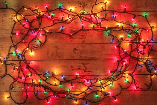 Christmas background with lights and free text space. Christmas lights frame. Garland. Flat lay, top view, copy space. Horizontal shot. 