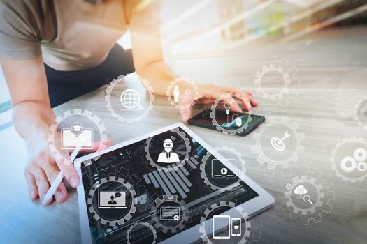 E-learning with connected gear cogs connected diagram virtual dashboard.businessman working with digital tablet computer and smart phonewith digital business strategy layer effect on wooden desk as concept