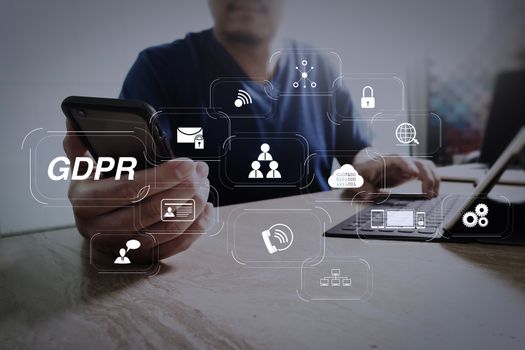 GDPR. Data Protection Regulation with Cyber security and privacy virtual diagram.designer using smart phone and keyboard dock digital tablet.Worldwide network connection technology interface.on marble desk.