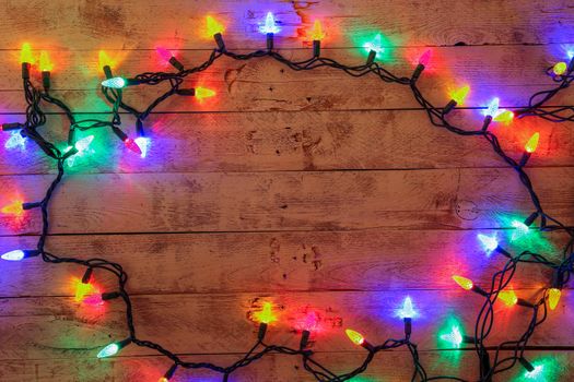 Christmas background with lights and free text space. Christmas lights frame. Garland. Flat lay, top view, copy space. Horizontal shot.