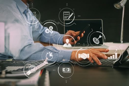 Business process management with workflow automation diagram and gears in virtual flowchart.businessman working with smart phone and digital tablet and laptop computer in modern office