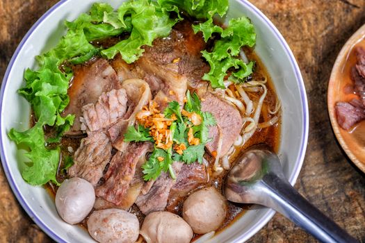 Thai food Noodle soup with beef on wood background