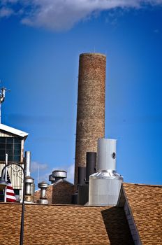 This is a unique collection of vents and smoke stacks  on a  bright day. 