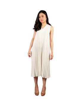 Young asian woman in white dress looking at the space for text on white isolate with clipping path