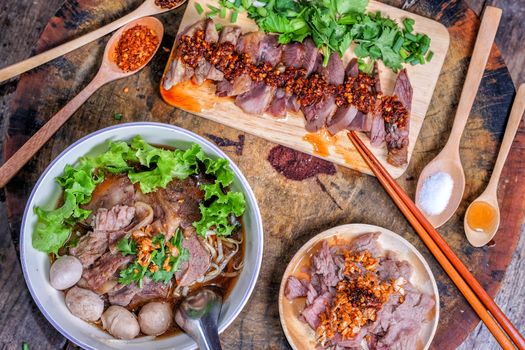 Thai food Noodle soup with beef on wood background