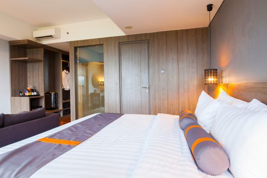 Interior of superior bedroom with white bed and pillow