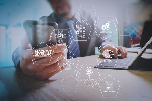 Machine learning technology diagram with artificial intelligence (AI),neural network,automation,data mining in VR screen.businessman using smart phone and keyboard dock digital tablet.Worldwide network connection.