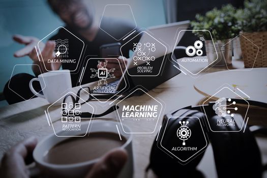 Machine learning technology diagram with artificial intelligence (AI),neural network,automation,data mining in VR screen.co working creative designers working at office and holding a cup of coffee and working on smart phone.