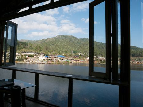 Scene of landscape view of village on mountain reflection on water from balcony view with cloudy sky