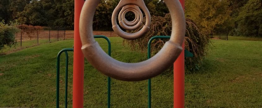 some metal rings lined up on a playground