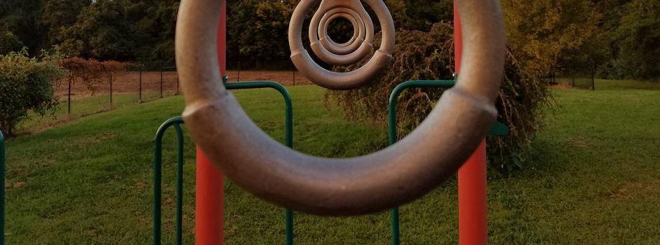 some metal rings lined up on a playground