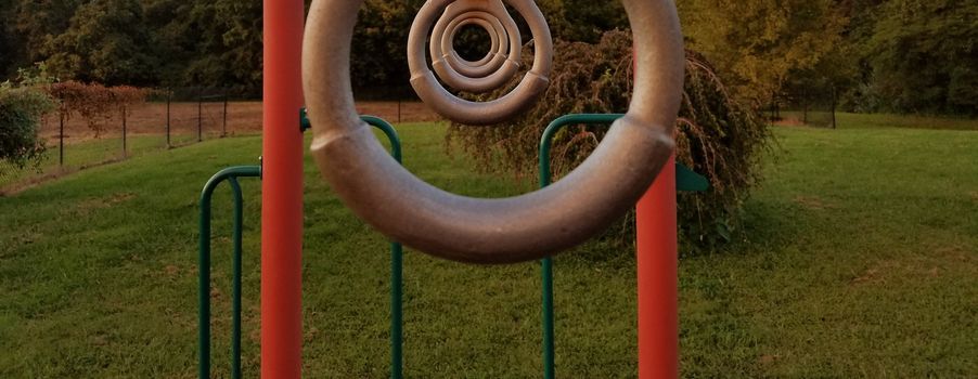 some metal rings lined up on a playground