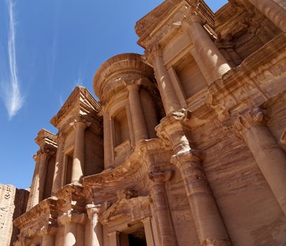 Photo taken at an oblique angle of a section of Al-Deir, the so-called monastery, in the necropolis of Petra, Jordan