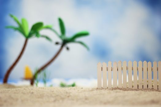 Picket Fence on Tropical Beach with Palm Trees