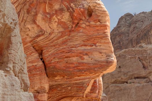 Sandstone coloured red, orange and black by iron and manganese compounds in the World Heritage of Petra, Jordan