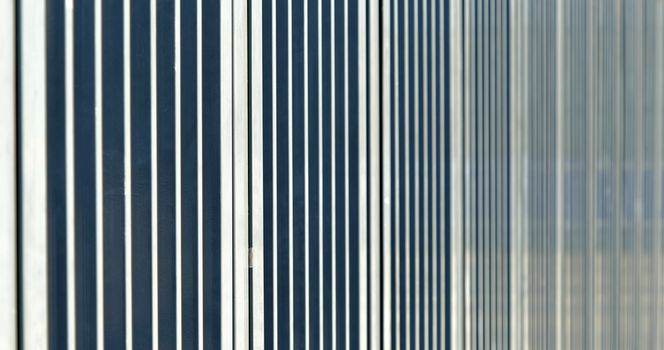 Abstract image with low depth of field (DOF) from the bars of a barrier before a sports stadium, germany