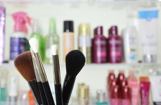 Various Beauty Products in shopping basket with blurred cosmetics in background