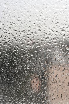 On a summer raining day. Drops of water on the window. Shallow DOF