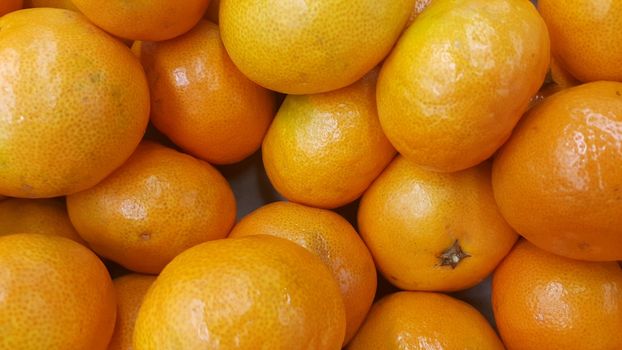 Fresh oranges in supermarket for sale, pile of orange in market for texture