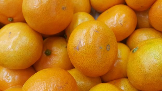 Fresh oranges in supermarket for sale, pile of orange in market for texture