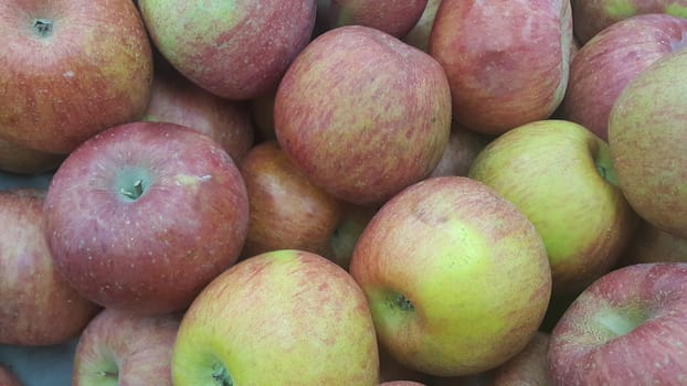 Fresh red and green Apples pile in market for sale. Fruit background for text or messages