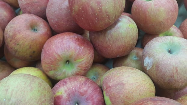 Fresh red and green Apples pile in market for sale. Fruit background for text or messages