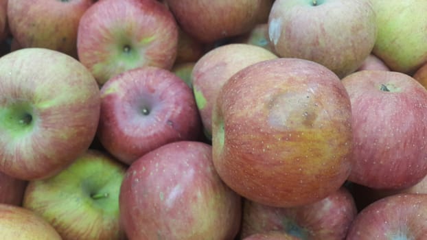 Fresh red and green Apples pile in market for sale. Fruit background for text or messages